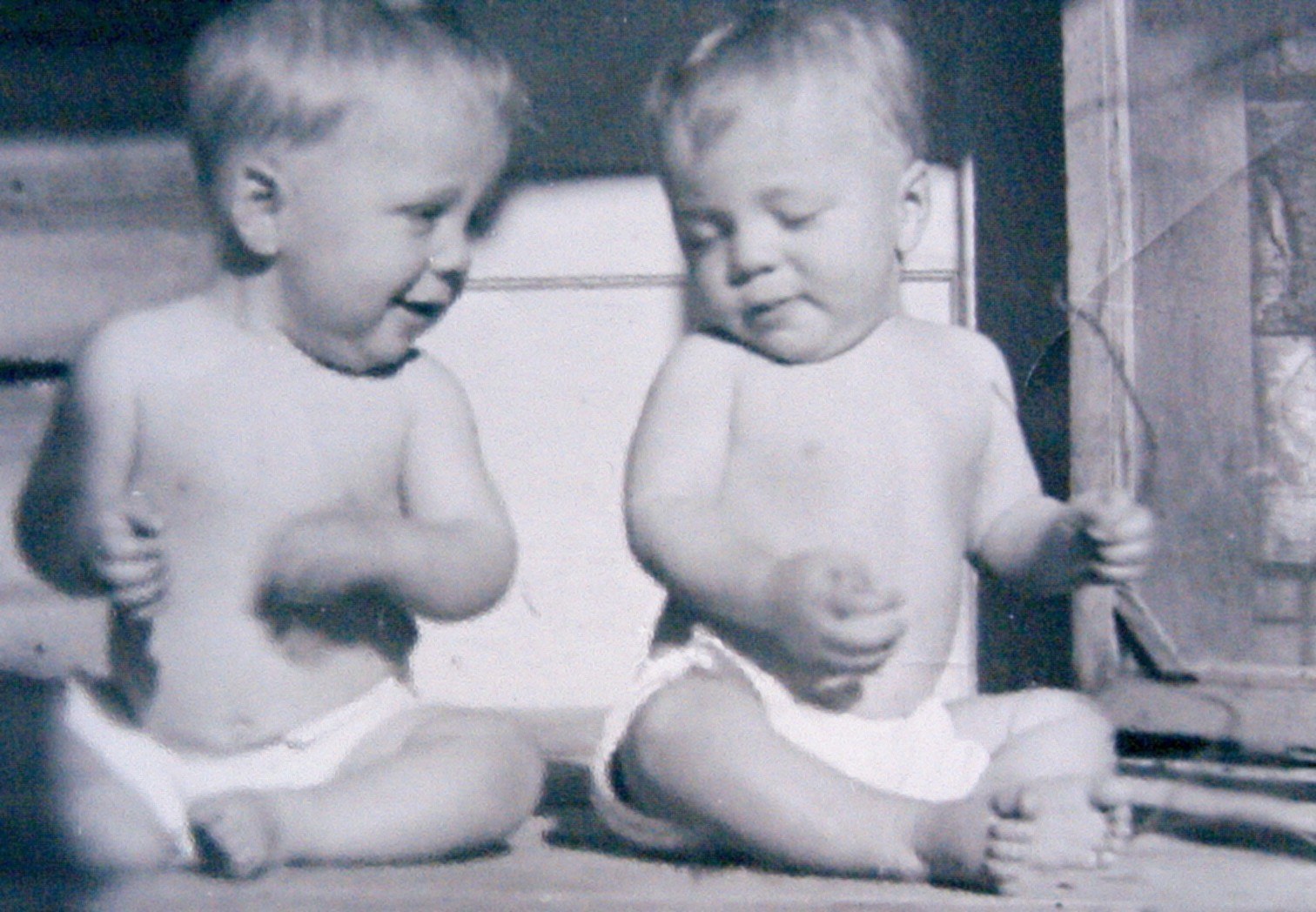 Infant twin brothers Marvin and Melvin Waldrip sitting side by side in cloth diapers