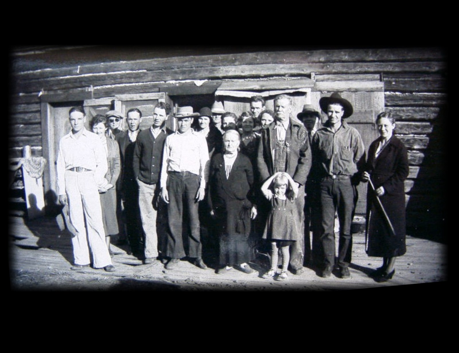 Large pioneer family group portrait in front of the Pleasant Valley cabin